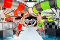 Two young boys in front of two water slides at the Therme Erding. 
