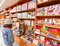 A child stands in a shop for children and looks at the products.