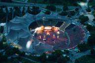 View from above of the packed Olympic Stadium and the brightly lit stage