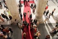 People on a red carpet at the entrance of the Bavarian State Opera during the Opera Festivals in Munich.