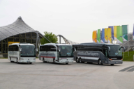 Three coaches are parked in the Olympic Park in Munich.