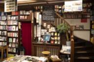 View into the bookshop Lentner in Munich with shelves, wooden stairs and a book table