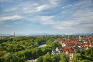 A view over green Munich and the Isar river to the mountains