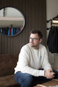 Fabio Di Salvo sits on a sofa in the Enzo Escoba brand shop.