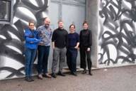 The Munich local love ambassadors have gathered in front of a wall of graffiti for a group photo.