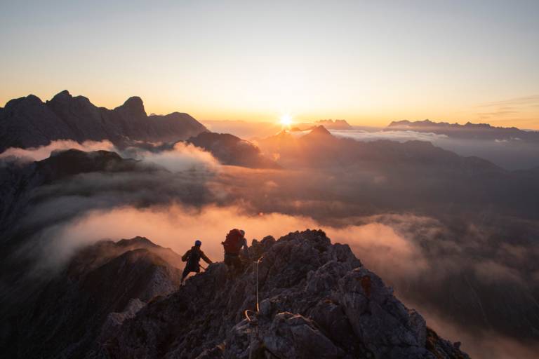 Two hiker are on a mountain ridge near Munich.