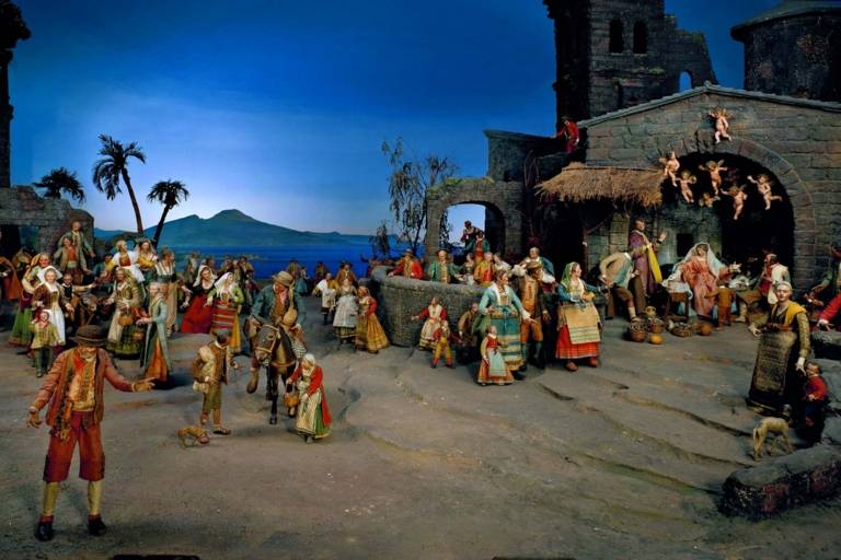 Nativity scene with figures in front of the Gulf of Naples with Vesuvius in the background.