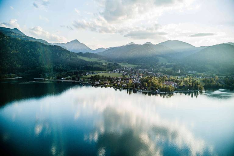 The Tegernsee in the evening light with cloud reflection on the lake surface near Munich.