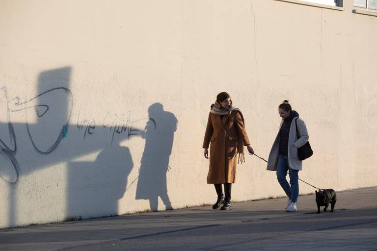 Our author walking with the owner of a café in Munich.