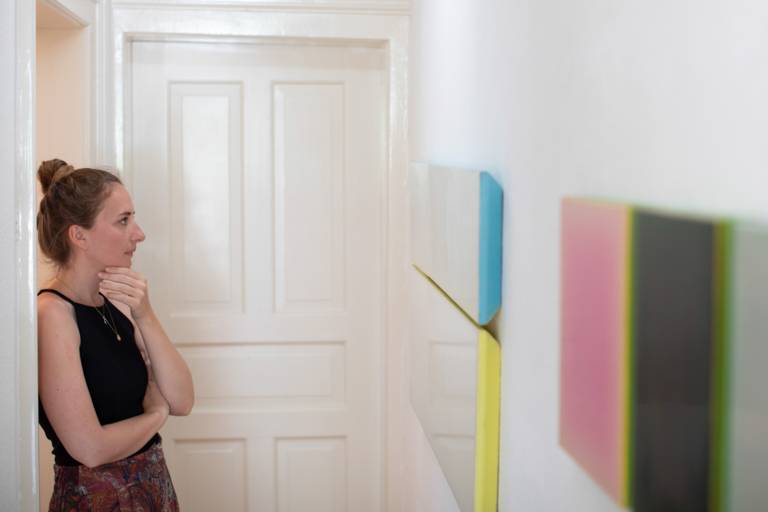 A young woman looks at pictures in a gallery in Munich.