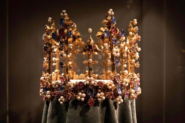 Golden crown with countless gemstones and pearls in the Residence Museum in Munich.