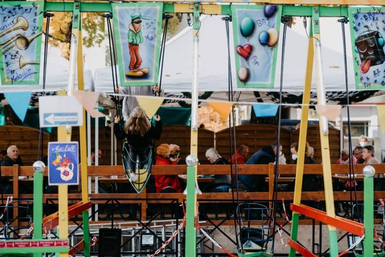 A girl swings on a ship's swing at the Auer Dult in Munich