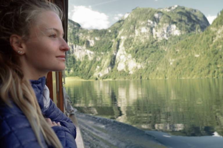 A young woman watching the Königssee from the ship