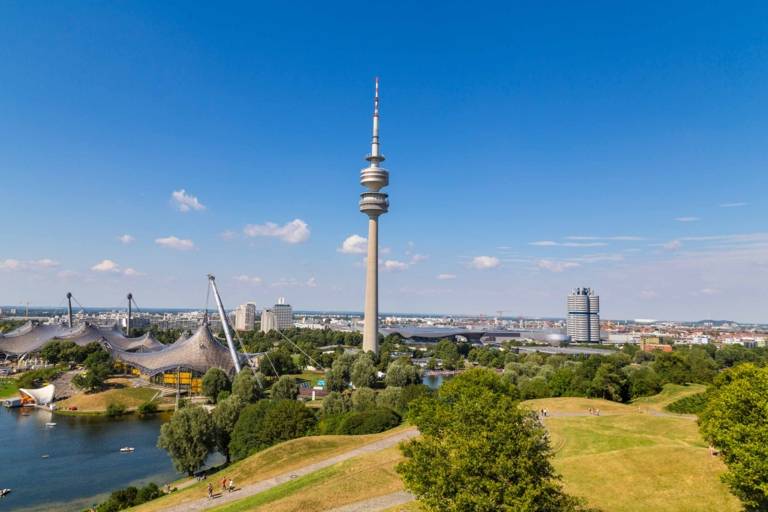 Panoramic view of the Olympic Park in Munich with the towers of the BMW Welt in the background.
