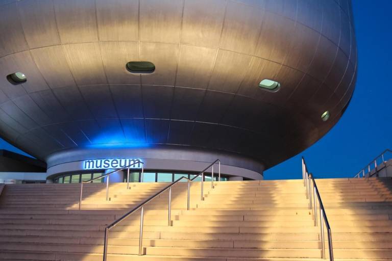 Entrance of the BMW Museum in Munich in the evening.