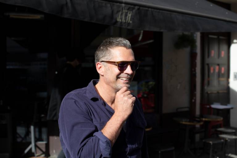 A man with grey hair and sunglasses