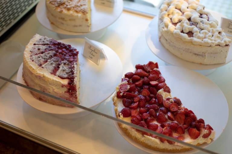 Different cakes next to each other in a cake counter