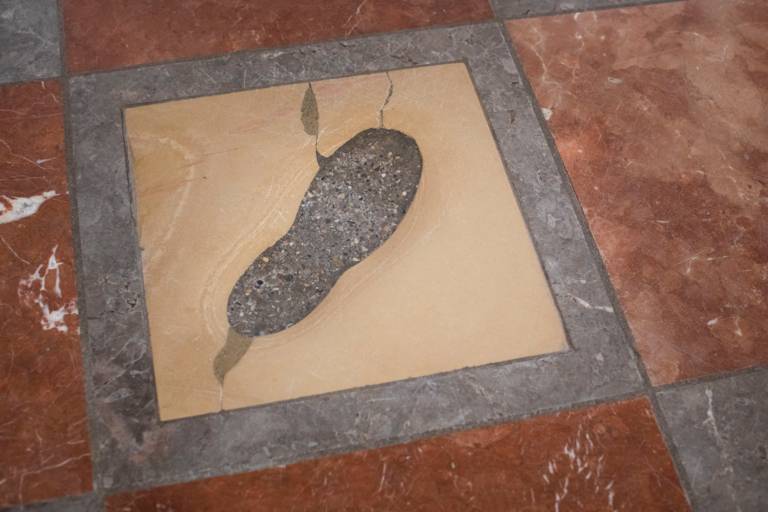 Footprint on a yellow stone slab