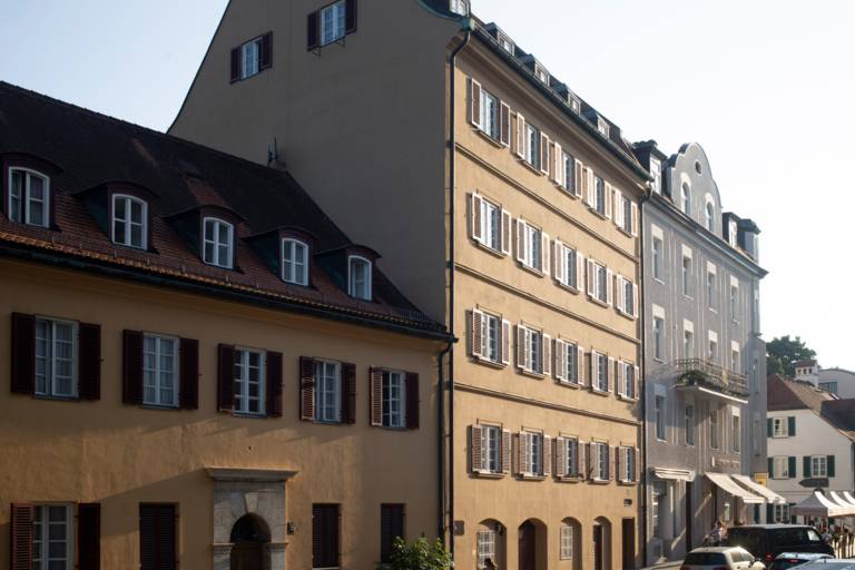 Several old building facades in the sunlight