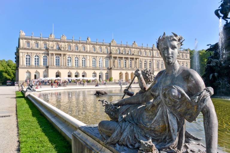 Herrenchiemsee Palace with the fountain and a fountain figure in the front. 