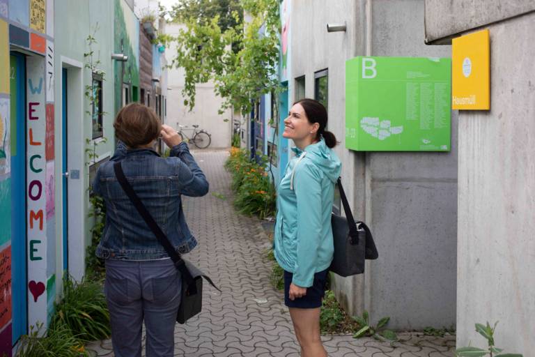 Visitors take photos of the colourful bungalows in the Olympic Village in Munich.