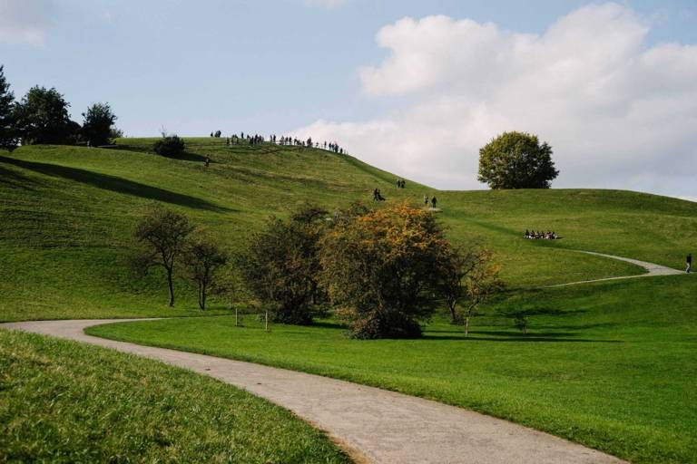 People standing on a hill at the Olympiapark in Munich