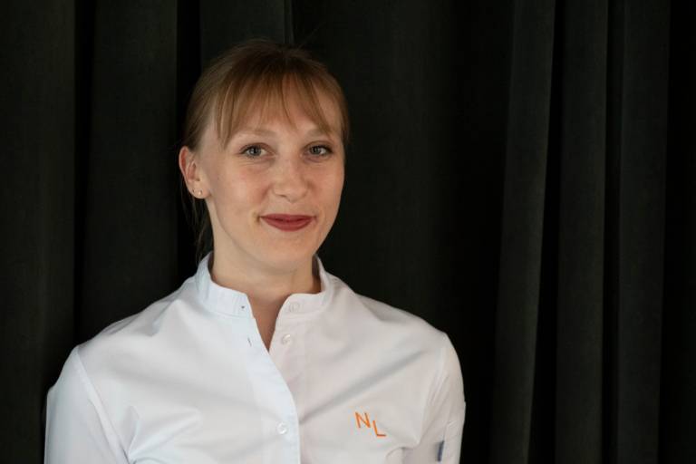 The star chef Nathalie Leblond in portrait with her white chef's jacket on