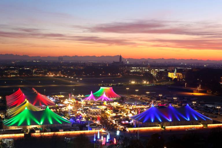 View from above of the illuminated Tollwood winter festival in Munich.