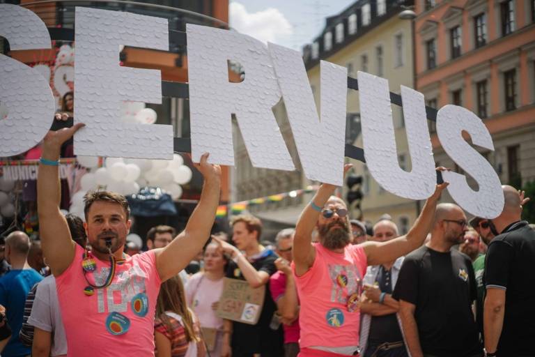 Men with a sign on Christopher Street Day in Munich